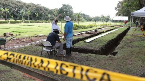 Employees work to exhume bodies at a private cemetery in Panama City, Panama June 16, 2020