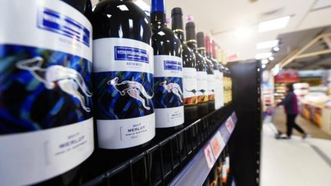 Bottles of Australian wine in supermarket aisle.