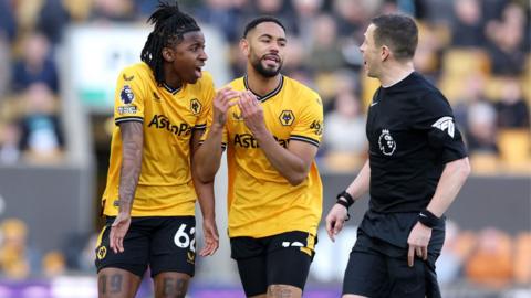 Wolves players argue with the referee