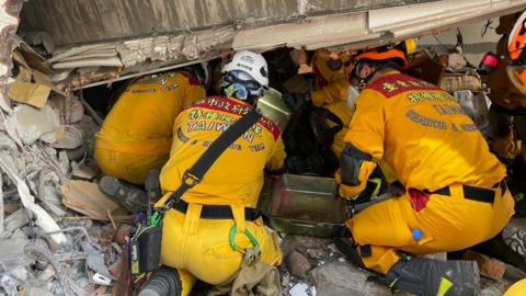 Members of a search and rescue team conducting rescue operations in a building in Hualien, Taiwan