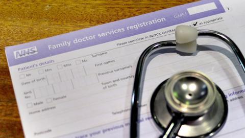 registration form and a stethoscope at the Temple Fortune Health Centre GP Practice near Golders Green, London.