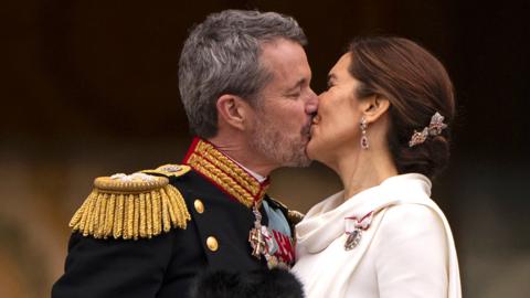 Denmark's King Frederik X and Queen Mary kiss on the balcony after the proclamation of the accession to the throne at Christiansborg Palace Square in Copenhagen, Denmark, on 14 January 2024
