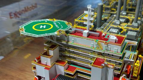 A miniature of Exxon Mobil’s Liza Unity oil platform is displayed at booth during Guyana’s Energy Conference & Exposition in Georgetown, Guyana