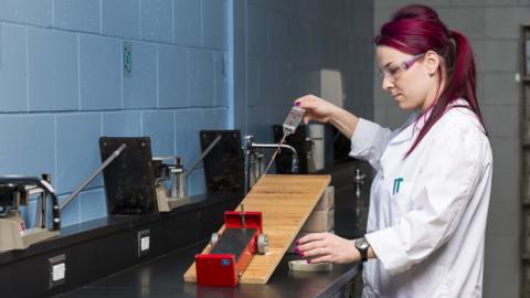 A student in a science lab, working on a practical experiment.