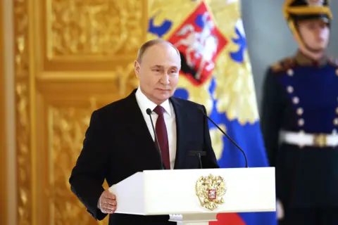 Russian President Vladimir Putin speaks during a meeting with his election campaign confidants at the Kremlin