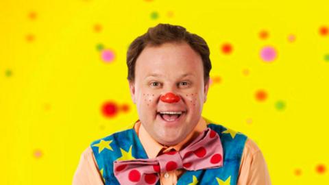 Mr Tumble is smiling