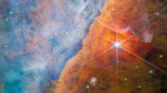 Stars shine through a sandy coloured nebula in an image taken by the JWST