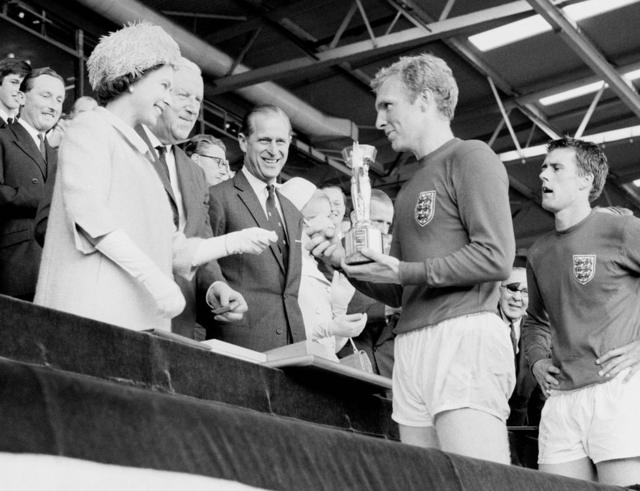 England captain Bobby Moore holds the Jules Rimet Trophy, collected from the Queen, after leading his team to a 4-2 victory over West Germany in the World Cup Final that went to extra time at Wembley, London