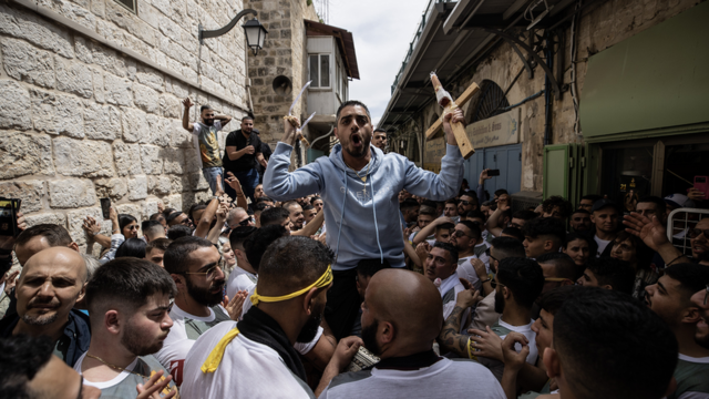 Orthodox Christians and priests walk to the Church of the Holy Sepulchre