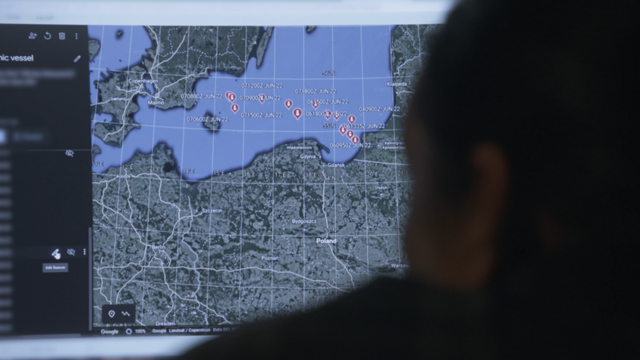 A former British intelligence officer tracking vessels on a screen