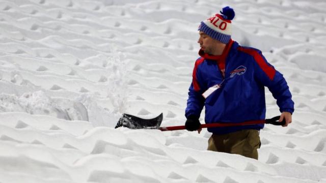 Stadium seats being cleared on snow on 17 December in New York