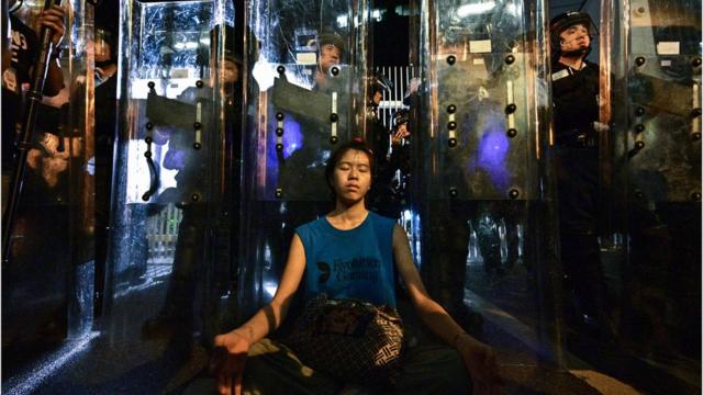 Женщина медитирует перед шеренгой полицейскихб 12 июня 2019, Гонконг