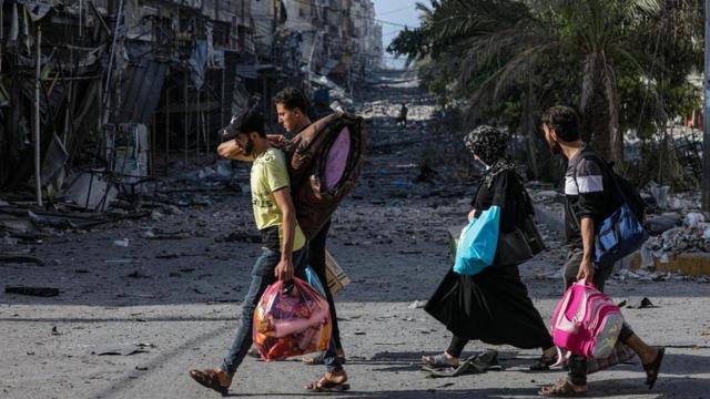 Residents evacuate Gaza City on foot during increased military operations in the northern Gaza Strip on 6 November 2023