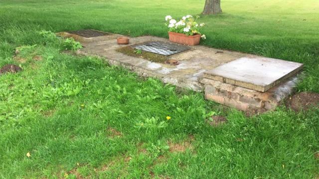 The cover of the septic tank where the female human remains were found on July 12.