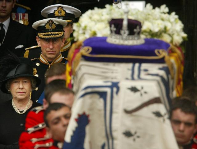 The Queen and Prince of Wales walk behind the Queen Mother's coffin, 2002