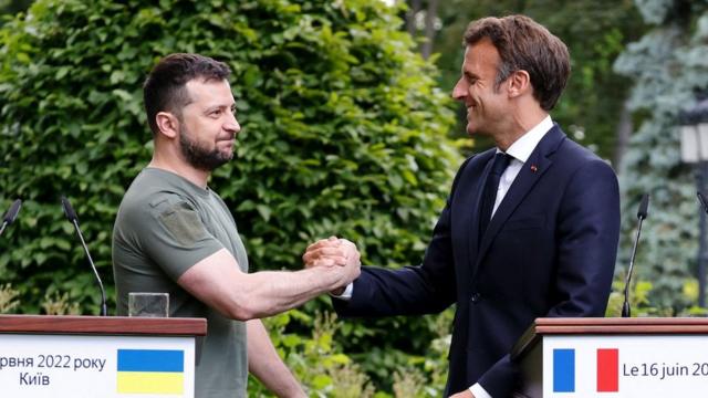 Ukrainian President Volodymyr Zelenskiy and French President Emmanuel Macron shake hands after giving a news conference, as Macron, German Chancellor Olaf Scholz and Italian Prime Minister Mario Draghi visit Kyiv, Ukraine June 16, 2022.