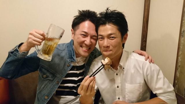 Yuichi Ishii toasting with beer in the company of a friend