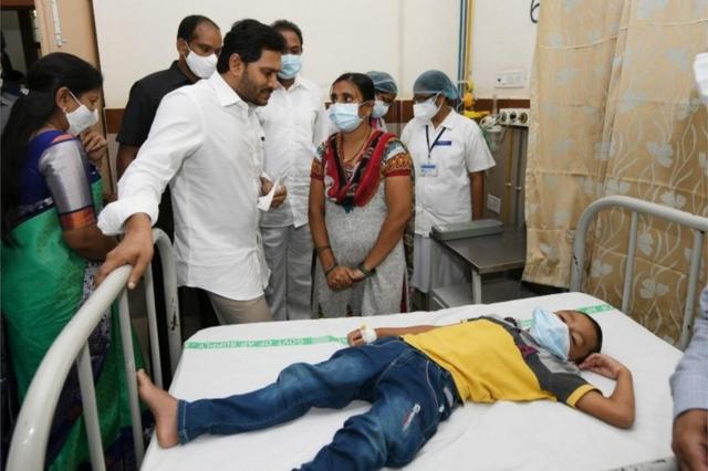 A handout photo made available by the Andhra Pradesh Government on 07 December 2020 shows the Andhra Pradesh Chief Minister Y.S. Jagan Mohan Reddy (C-L) meeting with the patients going under treatment for an unknown disease that left over 200 people hospitalised in Eluru town, Andhra Pradesh, India, 06 December 2020