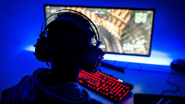 A teenage boy playing a video game