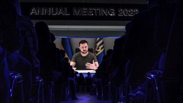 Ukrainian President Volodymyr Zelensky is seen on a giant screen during his address by video conference as part of the World Economic Forum (WEF) annual meeting in Davos on May 23, 2022.