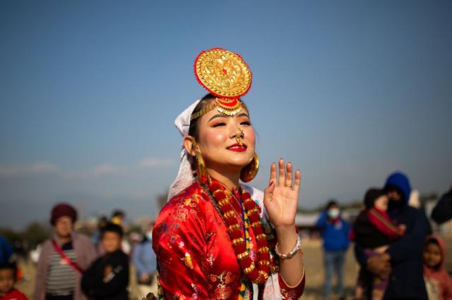 A woman from the Kirat community wearing traditional attire dances during the Sakela festival in Kathmandu, Nepal, 1 January 2022.
