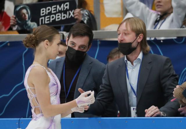 Figure skater Alexandra Trusova (L front) and coach Evgeny Plushenko (R) are seen during the women single's short programme on Day 2 of the Channel One Figure Skating Cup