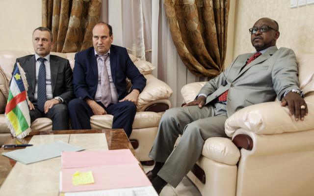 (LtoR) First Secretary at the Russian Embassy in the Central African Republic Victor Tokmakov, Special Security Advisor to the Central African President Valeriy Zakharov and Minister of Communication and Government Spokesman Ange Maxime Kazagui, meet in the office of the administrative building, on August 2, 2018 in Bangui. - Russia on August 2, 2018 said no sign of torture was found on the bodies of three Russian journalists killed during a reporting trip in the Central African Republic this week. Journalists Kirill Radchenko, Alexadner Rastorguyev and Orkhan Dzhemal were killed in the strife-torn African country on July 30, 2018. They were reporting on the so-called Wagner Group, a company that sends Russian mercenaries to hotspots such as Syria and Ukraine that has been described as Moscow's shadow army.
