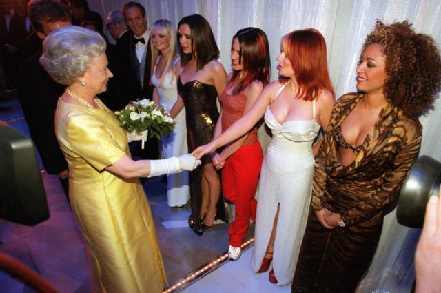 The Queen shakes hands with Geri Halliwell (Ginger Spice) of the pop group Spice Girls, 1997