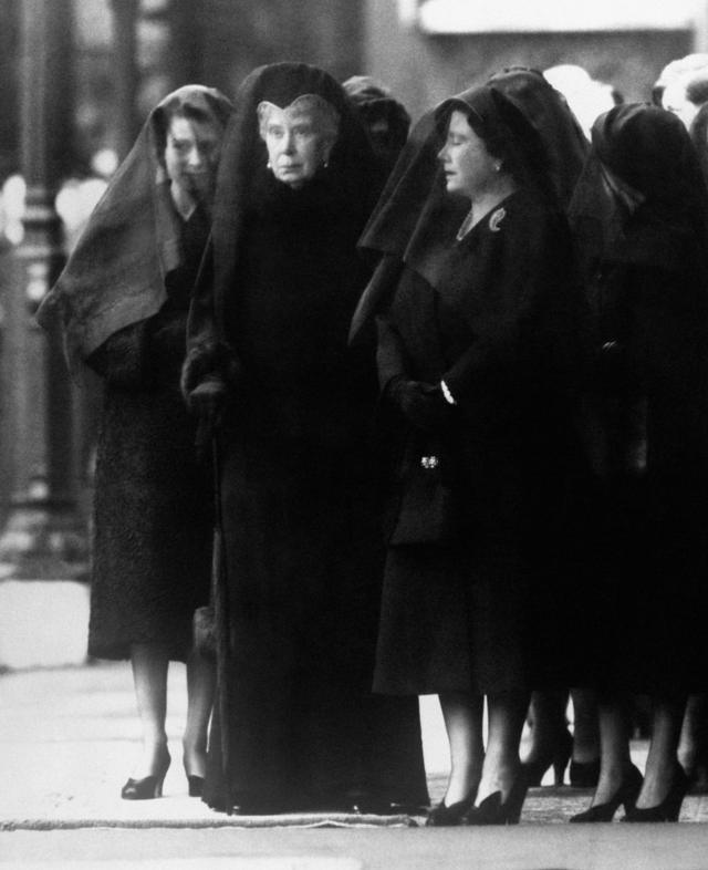 Queen Mary (centre) watches as the body of her son, George VI, is brought to Westminster Hall, London, for the lying-in-state. By her side, the Queen Mother, right, her eyes closed in grief. Queen Elizabeth II, veiled, stands behind her grandmother