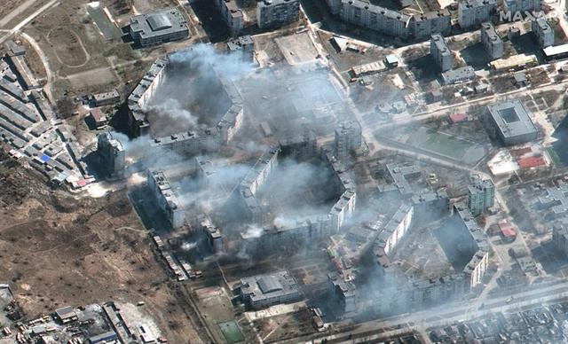satellite image of burning apartment buildings in northeastern Mariupol, Ukraine, 19 march 2022