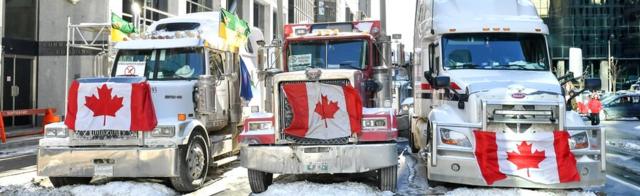 Truckers line up their vehicles as they prepare to honk their horns in Ottawa, Canada, 5 February 2022