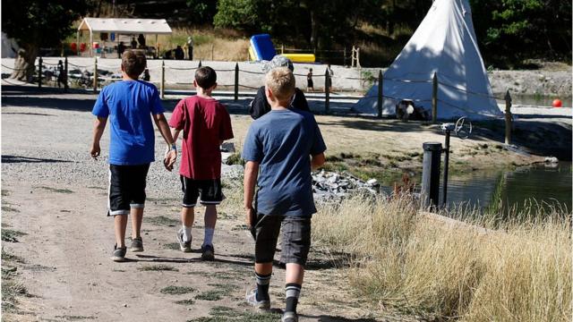 Boy Scouts walk around camp Maple Dell on July 31, 2015 outside Payson, Utah
