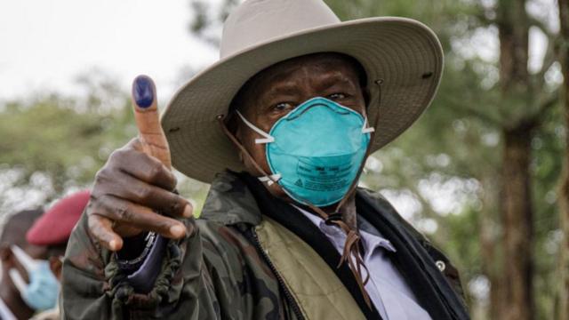 Ugandan President Yoweri Museveni holding up his ink-marked thumb after voting. Photo: 14 January 2021