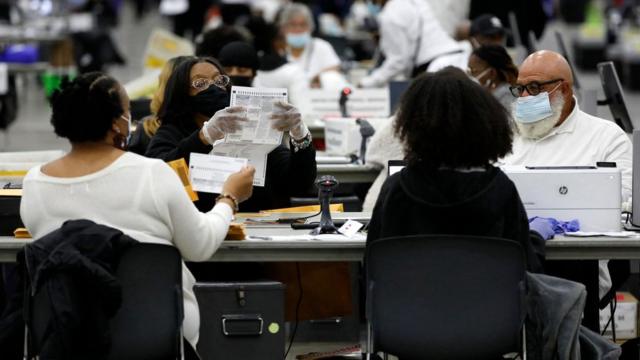 Election workers process absentee ballots cast in the US midterm elections