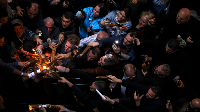 Orthodox Christians lighting their candles during the Holy Fire ritual