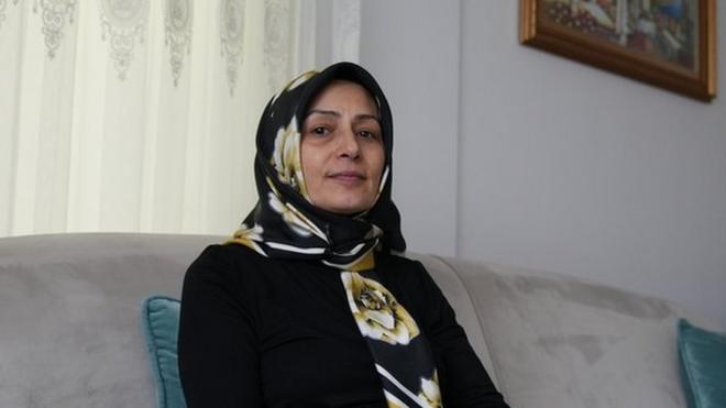 Nurgül Göksu sitting in her living room