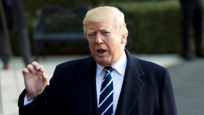 US President Donald Trump speaks with the media before boarding Marine One during his departure at the White House in Washington, DC, on December 2, 2017, en route to Joint Base Andrews.