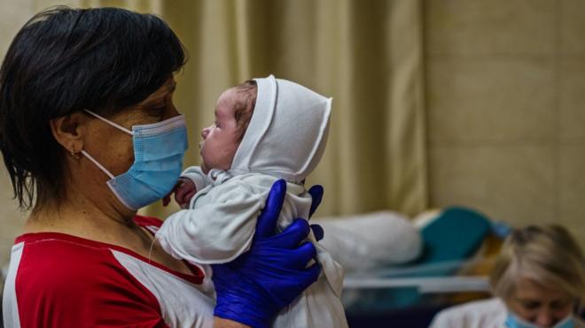 A nurse with a baby in Kyiv's underground nursery