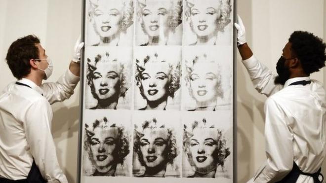 Sotheby's employees hold US artist Andy Warhol"s 'Nine Marilyn's'