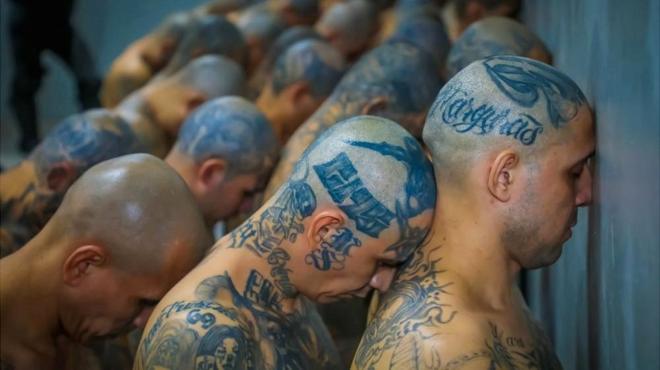 Gang members wait to be taken to their cells after 2000 gang members were transferred to the Terrorism Confinement Center