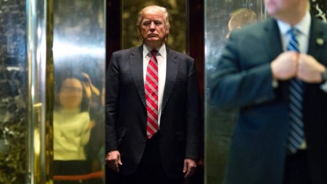 Donald Trump boards the elevator after escorting Martin Luther King III to the lobby after meetings at Trump Tower in New York City