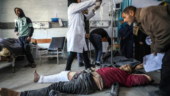 Palestinians receive medical care at Kamal Adwan Hospital in Beit Lahia, in the northern Gaza Strip, on 29 February 2024