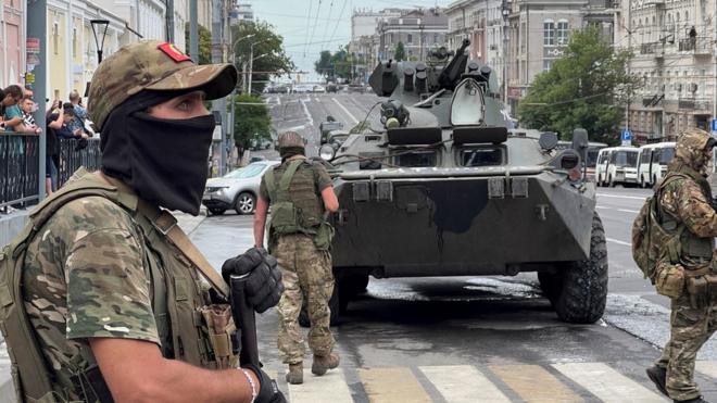 Fighters of Wagner private mercenary group stand guard in a street near the headquarters of the Southern Military District in the city of Rostov-on-Don, Russia, June 24, 2023.