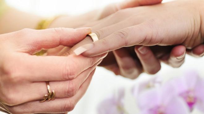 Women exchanging wedding rings