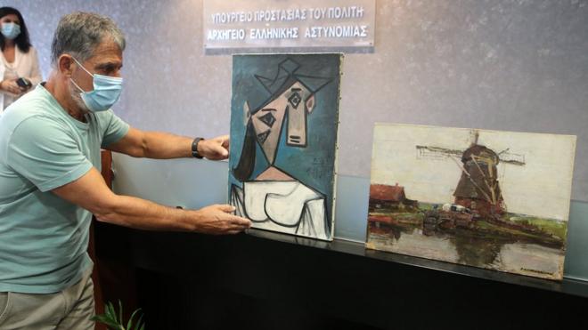 Greek Police officers presents the stolen Picasso and Mondrian paintings, at a press conference, in Athens, Greece, 29 June 2021