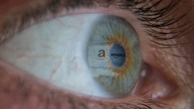 Reflexion of the Amazon logo in the eyes of a shopper