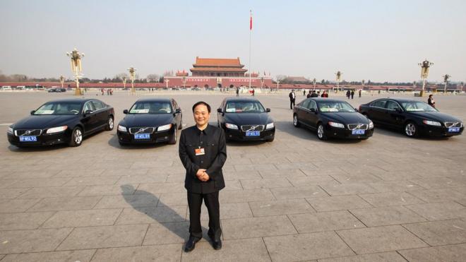 Li Shufu poses with Volvos at Tianmen Square in 2011