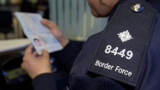 File picture of Border Force officer checking passport
