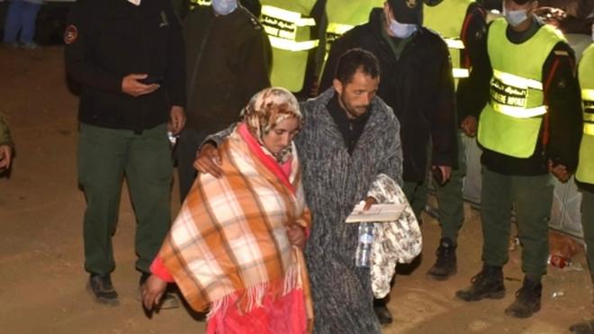 The parents of five-year-old Rayan are seen after rescue workers carried his body to an ambulance in Morocco's Chefchaouen province, 5 February 2022