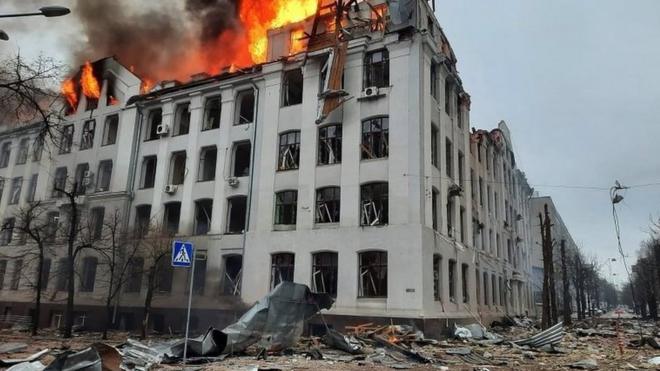 A building with blown out windows on fire